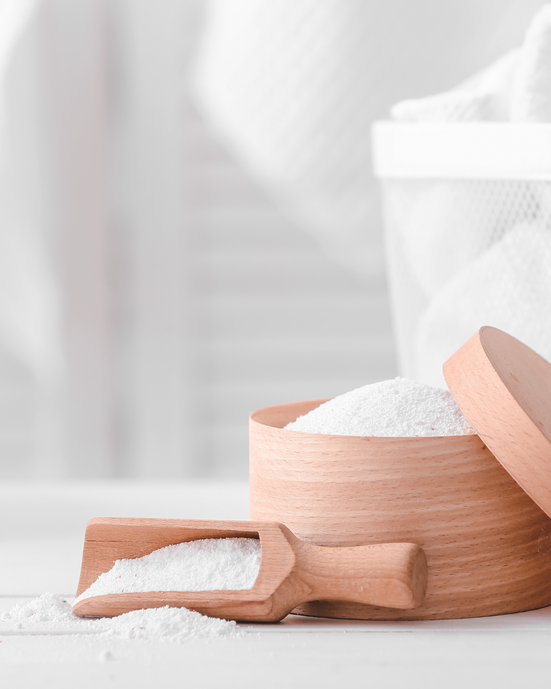 Nature-inspired container and wooden spoon with eco-friendly natural laundry powder, perfect for a clean and sustainable laundry routine.