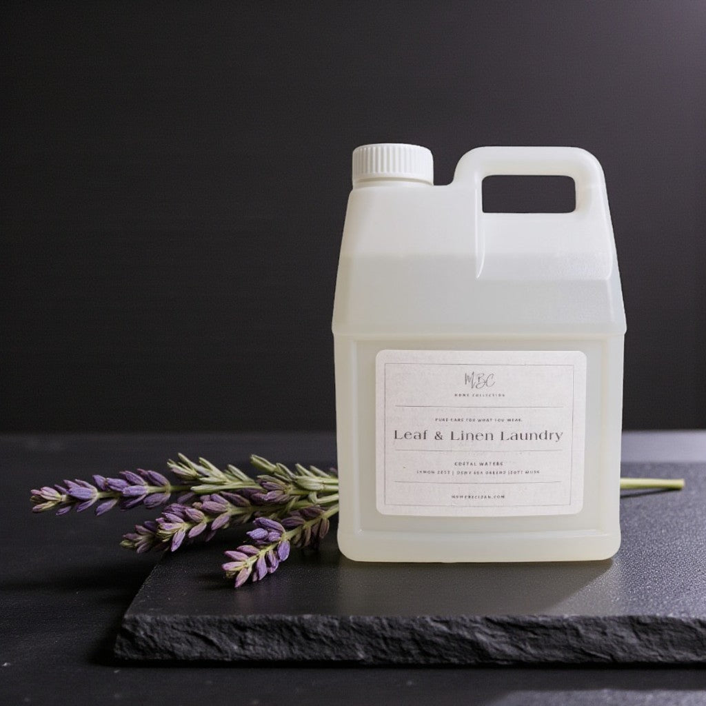 White laundry detergent container with lavender on a dark surface