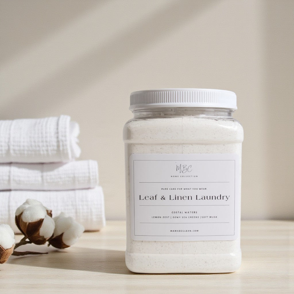 Jar of 'Leaf & Linen Laundry' detergent with cotton and towels in the background